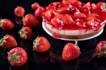 cheesecake with strawberry and fresh berries on black background
