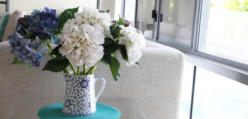 Beautiful white and blue imitation hydragrea flowers in blue and white vase