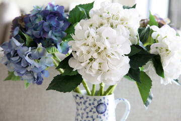 Beautiful white and blue imitation hydragrea flowers in blue and white vase