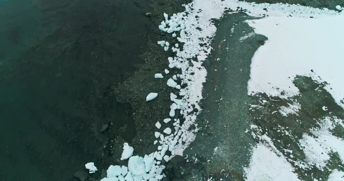 AERIAL MS Beached brash ice at coast of Mikkelsen Harbor / Antarctic Peninsula, Antarctica