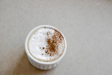 Cup of coffee cappuccino with cinnamon on natural linen background. Minimal food style.