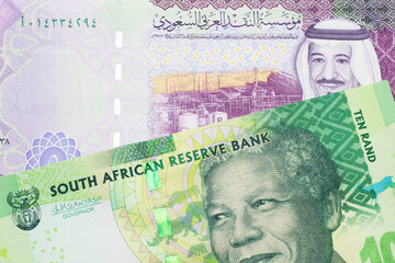 A green ten rand note from South Africa close up in macro with a colorful five Saudi riyal bank note