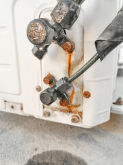 rusty humid leaking pipe of a central air conditioning system and cold water drops on it