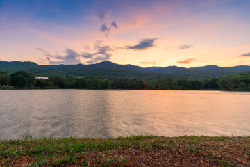 landscape lake views at Ang Kaew Chiang Mai University in nature forest Mountain views with evening blue dramatic sunset sky  background