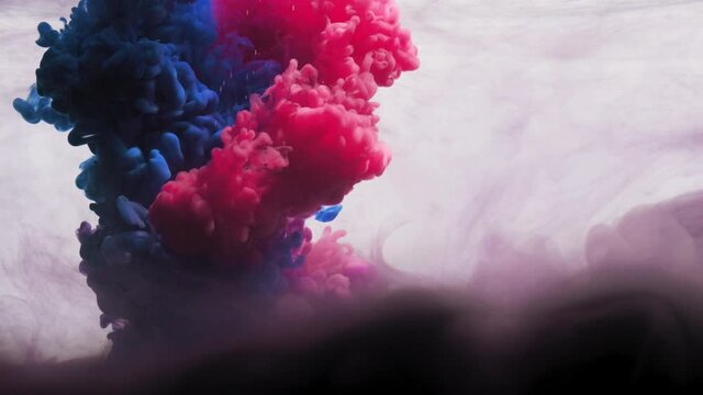 SLO MO CU Blue and pink ink dissolving in water / London, UK