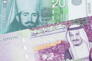 A twenty Serbian dinar bank note, close up in macro with a five Saudi riyal bank note