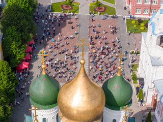 KOLOMNA, MOSCOW REGION, RUSSIA - JUNE 7, 2020: An aerial view of believers observing social distancing in front of the Assumption Cathedral during a religious service.