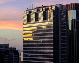 Beautiful cityscape with early morning sun and puffy pastel clouds. 