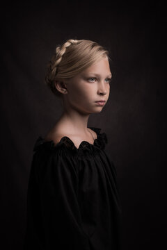 Painterly studio portrait of young blonde girl with braids