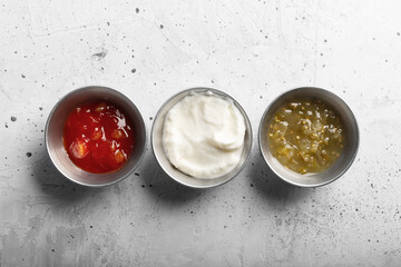 Traditional mexican sauces on the gray concrete background