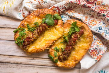 Hot pizza with sausage and cheese on wooden table. Food concept