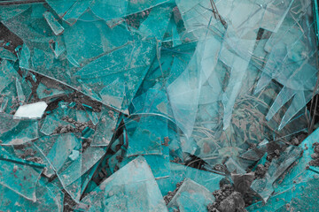 A shattered window on the ground. Broken glass background. Shards.
