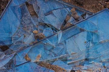 A shattered window on the ground. Broken glass background. Shards.
