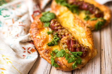 Hot pizza with sausage and cheese on wooden table. Food concept