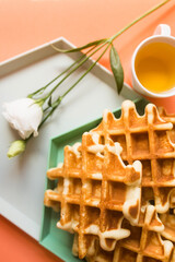 Viennese waffles on coral background