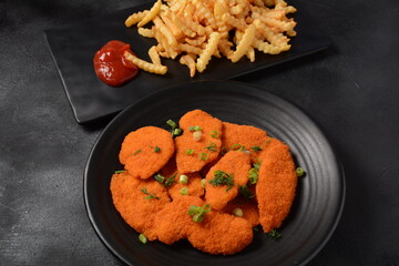 Chicken schnitzel or nuggets with chips and ketchup