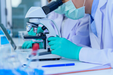 Scientist team has researching and working on Coronavirus cure in the laboratory. Asian Doctor...