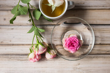 Flowers roses in blossom on wooden table