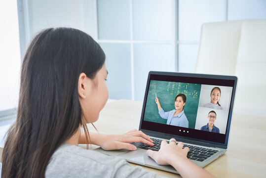 Asian schoolgirl online learning with laptop at home. Education and distance learning for kids. Homeschooling during quarantine.