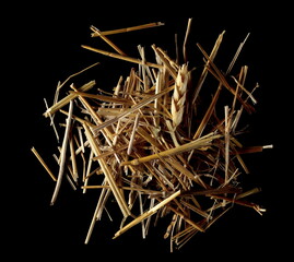 Straw, thatch, hay pile isolated on black background and texture, top view