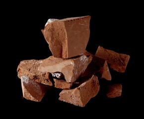 Broken brick pieces, chunks for bricklaying and construction isolated on black background