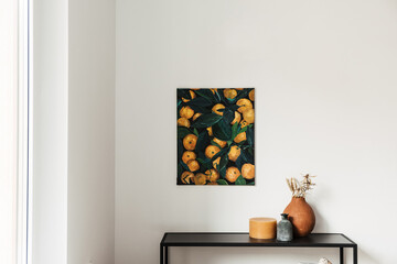 Modern interior design concept. Oil painting canvas with oranges on the wall. Candle, clay pot with dry plants.