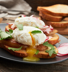 sandwich on toasted white slice of bread with poached eggs