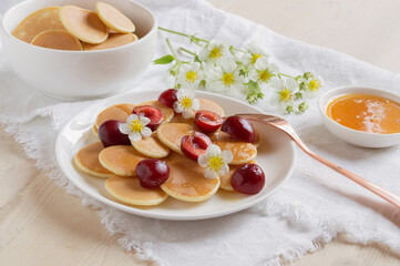  small pancakes with berries for Breakfast.