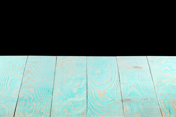 Blank blue wooden textured table on a black background.