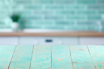 Wooden textured blue table on a background of blurred interior.