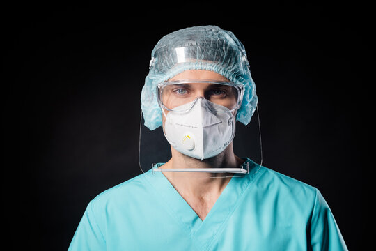 Closeup Photo Of Nurse Guy Expert Doc Virologist Covid19 Protection Control Concept Wear Mask Blue Uniform Suit Gown Plastic Facial Goggles Surgical Cap Isolated Black Color Background