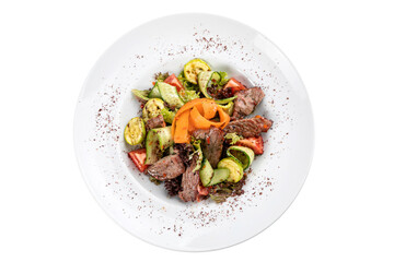 Grilled veal salad on a white plate and on a white isolated background. Grilled veal, carrots, vegetables
