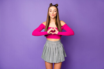 Photo of adorable attractive lady making heart shape fingers send kisses wear pink off-shoulders cropped top short plaid skirt isolated pastel purple color background