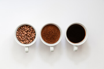 Flat lay view of, coffee beans, grinded coffee and ready to drink coffee in a cup