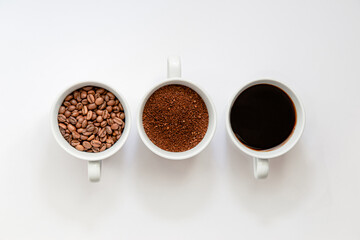 Flat lay view of, coffee beans, grinded coffee and ready to drink coffee in a cup