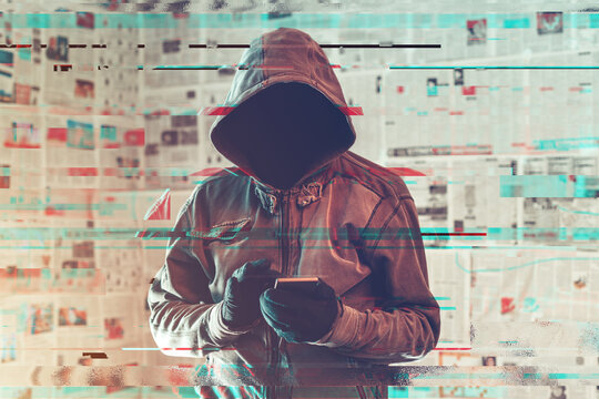 Hooded hacker person using smartphone in infodemic concept