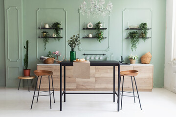 Scandinavian classic kitchen with wooden decor and green plants, minimalistic interior design. Real photo. Eco home decor.