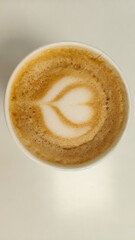 Top view of hot coffee - the perfect heart shaped capuccino