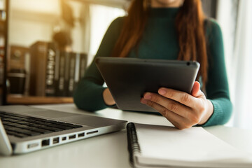 Businesswomen analyzing investment graph and discussing plan in office room 