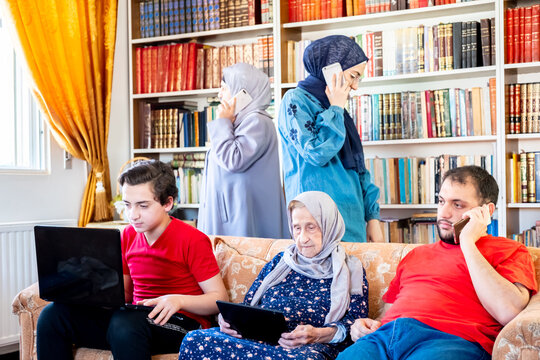 Arabic Family In The Same Room Togther But Everyone Is Busy With