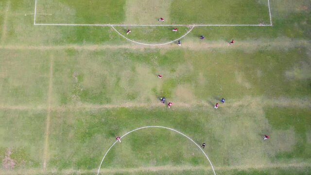 Zoom out aerial image of amateur football match. São Paulo, Brazil.