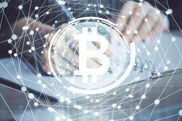 Cryptocurrency hologram over hands taking notes background. Concept of blockchain. Multi exposure