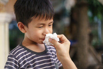 Asian boy with nose bleeding problem
