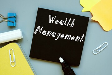 Financial concept meaning Wealth Management with inscription on the piece of paper.