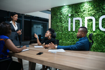 Businesswoman talking with her staff during a boardroom meeting