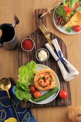 Tasty Pizza Roll with Vegetable. Served on White Plate and Cream Cake Stand. Party Table Setting with Fresh Food