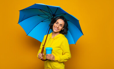 Enjoying the rainy day . Half-length photo of sweet girl with wide smile on her face under an...