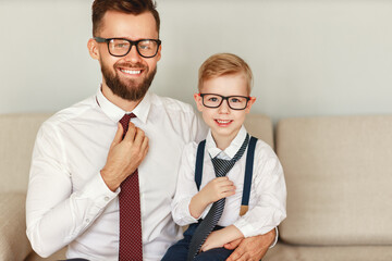 A cheerful man with a child in official clothes