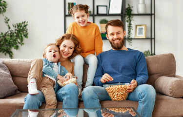 Joyful family resting on sofa together.