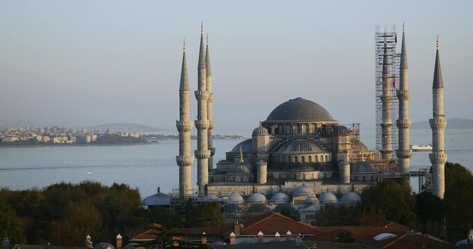 Sunset timelapse over the Blue Mosque (Sultanahmet Camii) in Istanbul with cargo ships fast crossing the Bosphorus